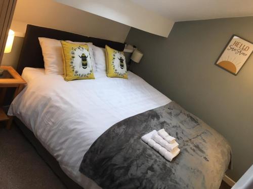 a bedroom with a large bed with yellow pillows at Pennine View - Manchester: Rochdale Littleborough in Littleborough