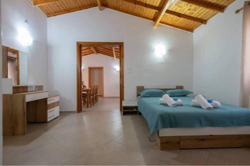 a bedroom with a bed and a sink and a mirror at Platy Sea View Lxs in Plati