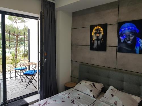 a bedroom with a bed and a view of a patio at Sunrise Arcadia Sky in Odesa