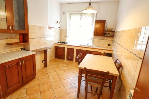 a kitchen with a table and a table and a window at La Pulce Salata in Levanto