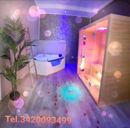 a large bathroom with a tub and a potted plant at Suite Natura Bed&Beauty Spa in Taranto