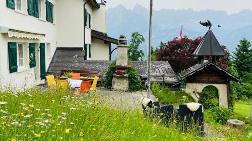 a house and a garden with a gazebo at Casa Fluretta in Flumserberg
