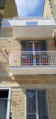 a balcony on a building with chairs on it at Bed and Breakfast il Pesciolino in Trani