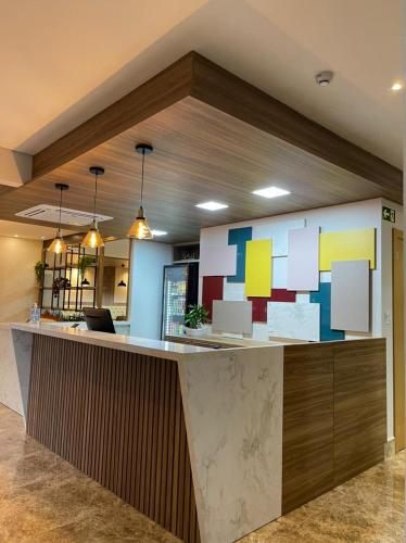 a lobby with a reception counter in a building at Arca's Executive Hotel in Toledo
