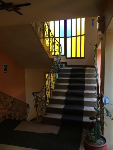a staircase in a house with stained glass windows at Royal Inn Hotel Puno in Puno