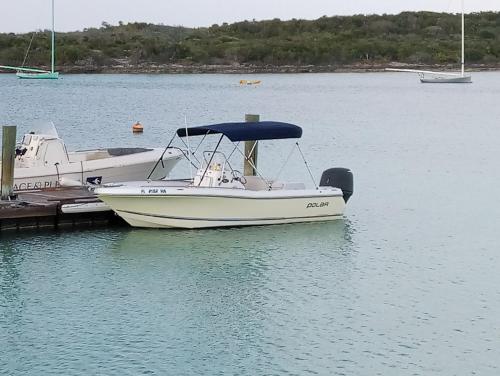 a white boat docked at a dock in the water at Da Sugar House in Georgetown