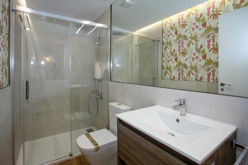 a bathroom with a toilet and a sink and a shower at -La Olmeda- La Casona del Zoilo in El Burgo de Osma