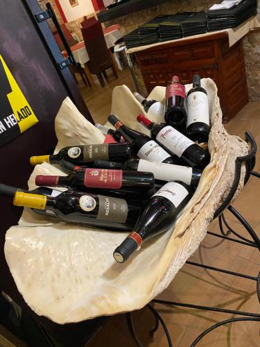 a bunch of wine bottles sitting in a basket at Alquiler de Habitacion Privadas con Baño compartido Y áreas comunes in Alcalá