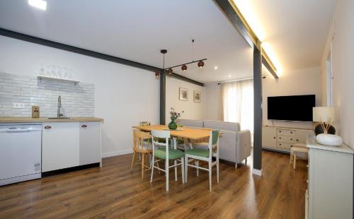 a kitchen and dining room with a table and chairs at -La Olmeda- La Casona del Zoilo in El Burgo de Osma
