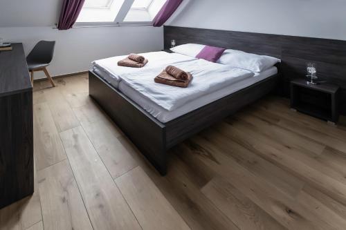 a bedroom with a bed with two towels on it at Vinařství Herůfek in Zaječí
