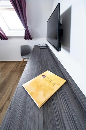 a book on a wooden desk in a room at Vinařství Herůfek in Zaječí