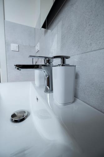 a bathroom sink with a faucet on top of it at Vinařství Herůfek in Zaječí