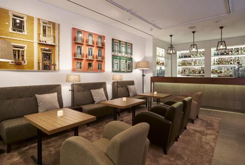 a restaurant with couches and tables and chairs at PortoBay Marquês in Lisbon