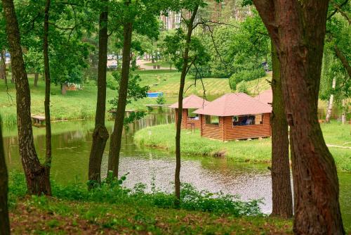 a cabin in the middle of a pond in a park at Kryve Ozero in Novoyavorivsk