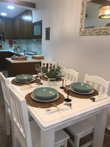 a dining room table with green plates on it at Casa D'Aldeia in Aldeia da Mata