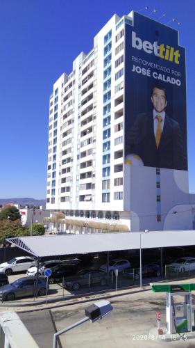 a large building with a sign on the side of it at Ricardo Rolão Vista Mar - Edifício Oásis - Bedrooms in Faro