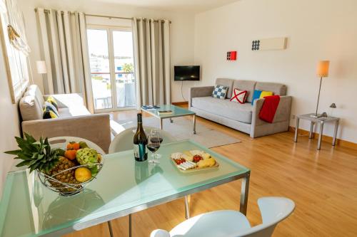a living room with a table with a bowl of fruit at Marina Club Lagos Resort in Lagos