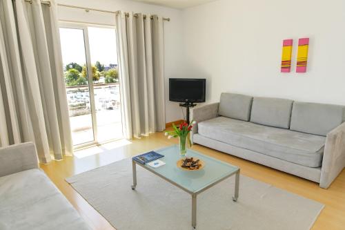 a living room with a couch and a table at Marina Club Lagos Resort in Lagos