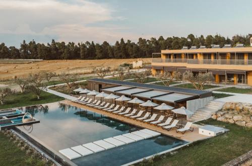 an aerial view of a resort with a pool and chairs at Sani Verde in Sani Beach