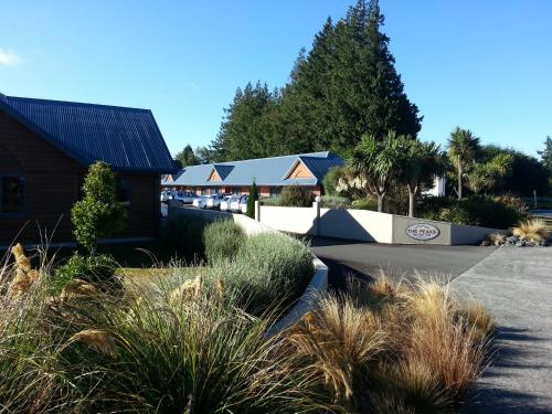 a building with a sign on the side of a road at The Peaks Motor Inn in Ohakune