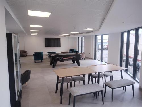 a room with two tables and a pool table at CP Top floor luxury studio in Gibraltar