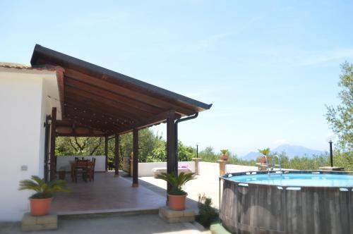 a patio with a swimming pool and a pergola at Casa Jumasca in Massa Lubrense