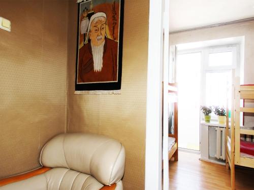 a living room with a couch and a painting on the wall at Top Tour & Guesthouse Mongolia in Ulaanbaatar