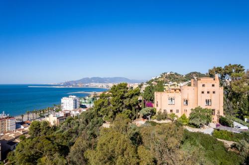 a large building with a view of the ocean at Soho Boutique Castillo de Santa Catalina - Adults Recommended in Málaga
