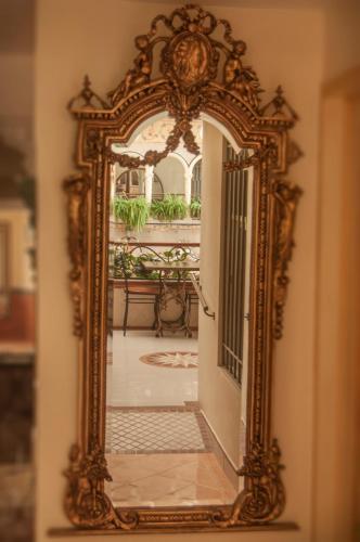 an ornate mirror on a wall in a room at Villa Las Margaritas Caxa in Xalapa