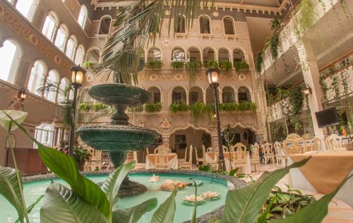 a large building with a pool with people in it at Villa Las Margaritas Caxa in Xalapa