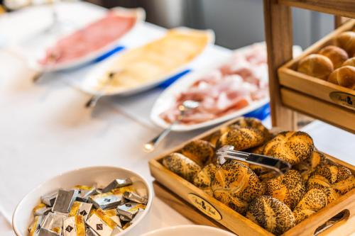 a table topped with trays of food and other foods at Hotel Malpertuus in Riemst