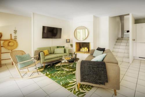 a living room with a couch and a fireplace at Villa Samasti - OVO Network in Lacanau