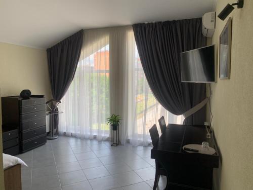 a room with a desk and a large window at ZIG ZAG in Kamianets-Podilskyi