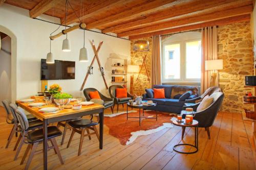 a living room with a table and a couch at Le SwansDoors - OVO Network in Annecy