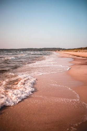 a beach with the ocean and the waves at Salines in Hyères