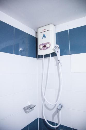 a shower in a bathroom with a shower head at Happyland Mansion in Bangkok
