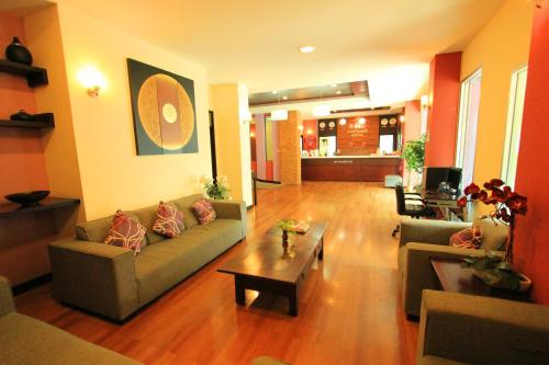 a living room with a couch and a coffee table at Happyland Mansion in Bangkok