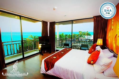 Schlafzimmer mit einem Bett und Meerblick in der Unterkunft Royal Thai Pavilion Jomtien Hotel in Jomtien Beach