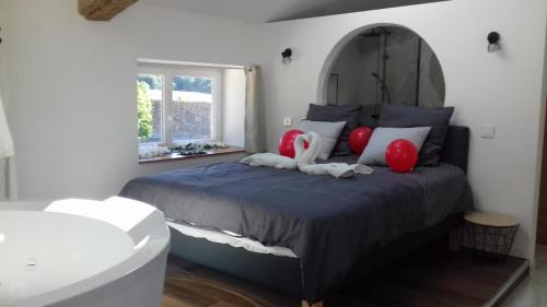 a bedroom with a large bed with red pillows at 04A2 - Paradise Love In Provence - le loft étoilé - spa privatif in Reillanne