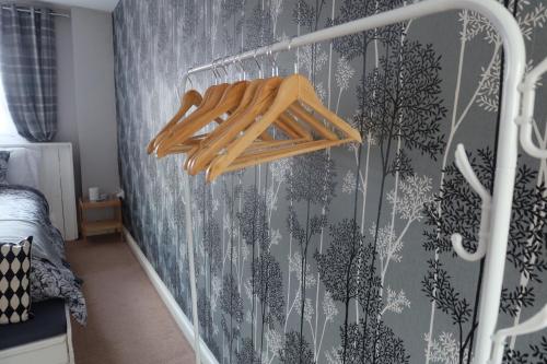 a bedroom with a gray and white wall at 15 Bronant in Talgarth