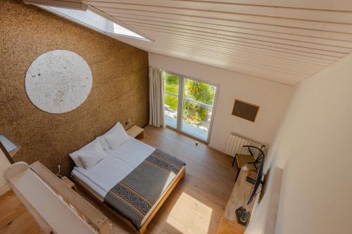 an overhead view of a bedroom with a bed and a window at Cavalo de Madeira in Arelho
