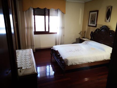 Schlafzimmer mit einem Bett und einem Fenster in der Unterkunft Casa Florida® in Vigo
