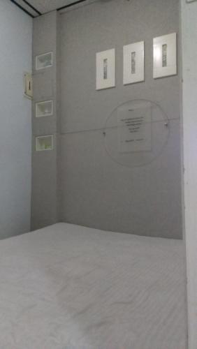 a room with a white wall with pictures on it at Art Taiwan Homestay in Shunan