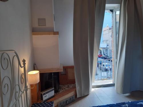 a bedroom with a fireplace with a view of a city at Stefi Appartamento, Camera in Falconara Marittima