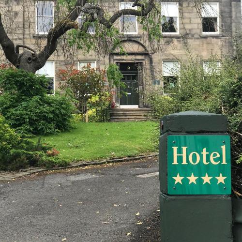 a hotel sign in front of a building at Ashtree House Hotel, Glasgow Airport & Paisley in Paisley