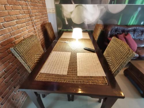 a table with two chairs and a lamp on it at Captivating 4-Bed Apartment in Kotka SaunaFacility in Kotka