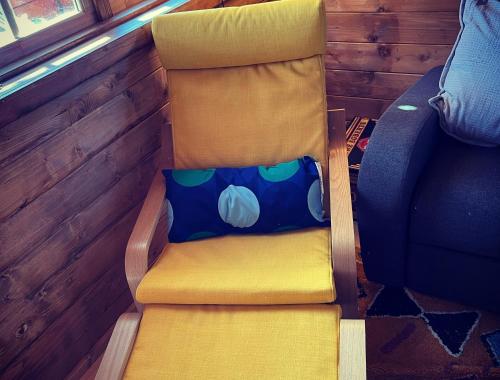 a chair with a pillow sitting on top of it at Retro Lodge nr Dartoor with hot tub & opt sauna in Newton Abbot
