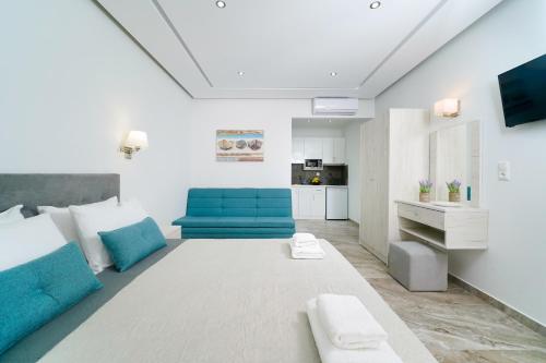 a bedroom with a large bed and a blue chair at Tarsa's House by the Sea in Skala Marion