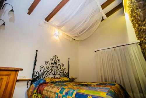 a bedroom with a bed with a colorful blanket at Casita del Castillo in Denia