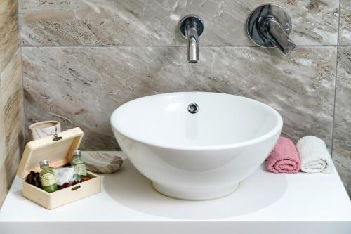 a bathroom with a white sink on a counter at Tarsa's House by the Sea in Skala Marion